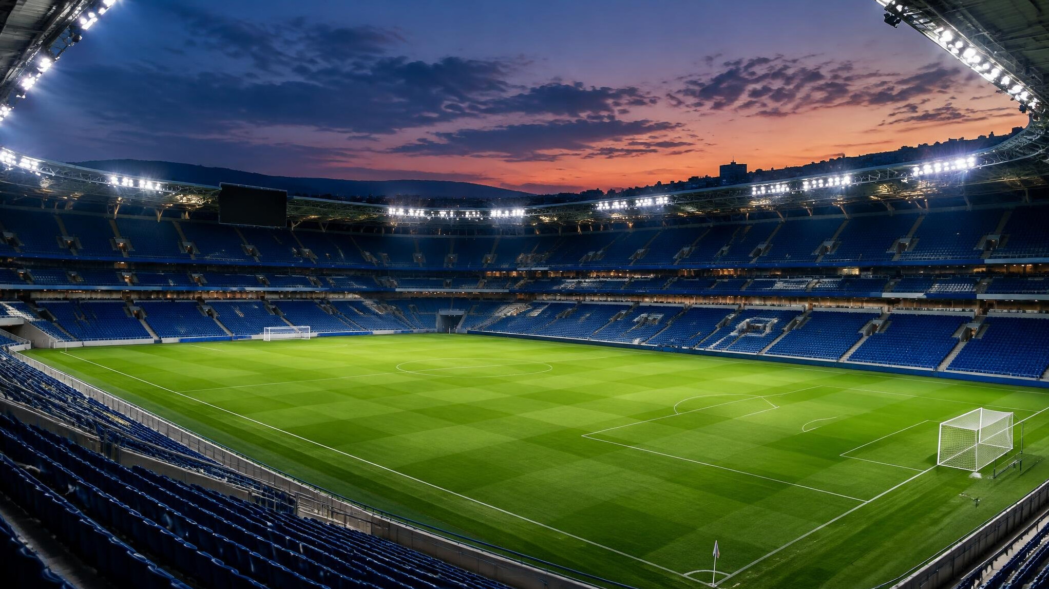 Empty football stadium seating under stadium lights